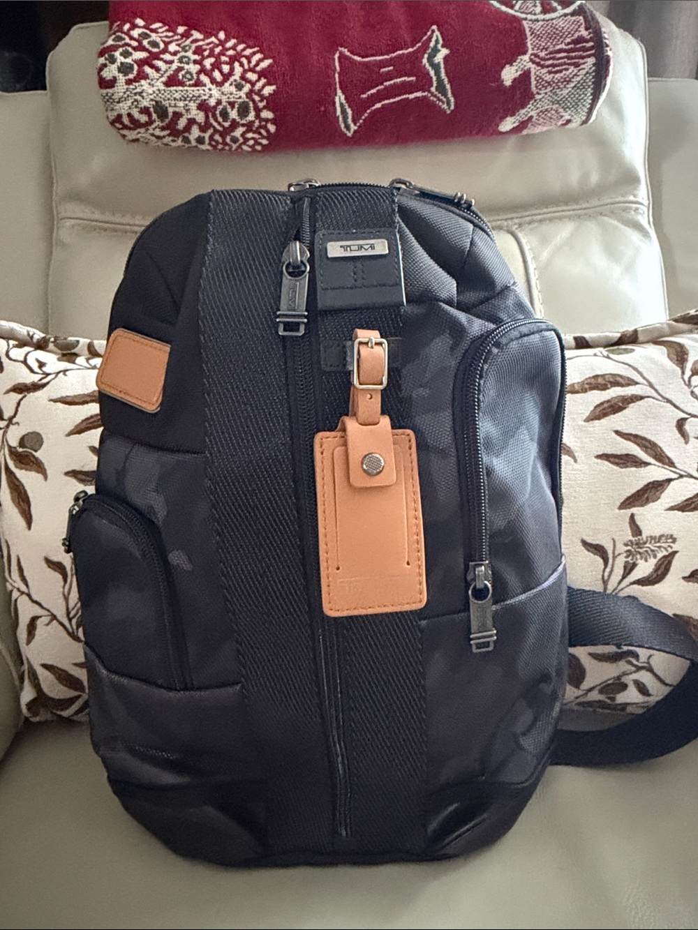 Tumi Black Sling Backpack with Tan Leather Tag and Trim